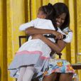 Michelle Obama serre une petite fille dans ses bras lors d'une rencontre avec les enfants des employés de la Maison-Blanche.