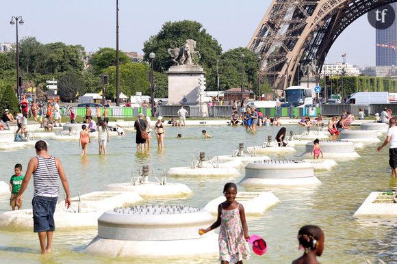 Canicule 2015 : les Parisiens viennent chercher de la fraîcheur dans la fontaine du Trocadéro et celle du Champ de Mars. 