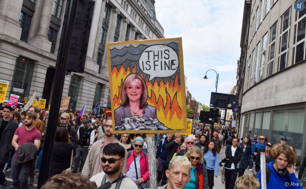   Un manifestant tient une pencarte caricaturant la Première ministre britannique Liz Truss pendant la marche organisée par  Just Stop Oil et Extinction Rebéllion à Londres, le 2 ocotobre 2022 