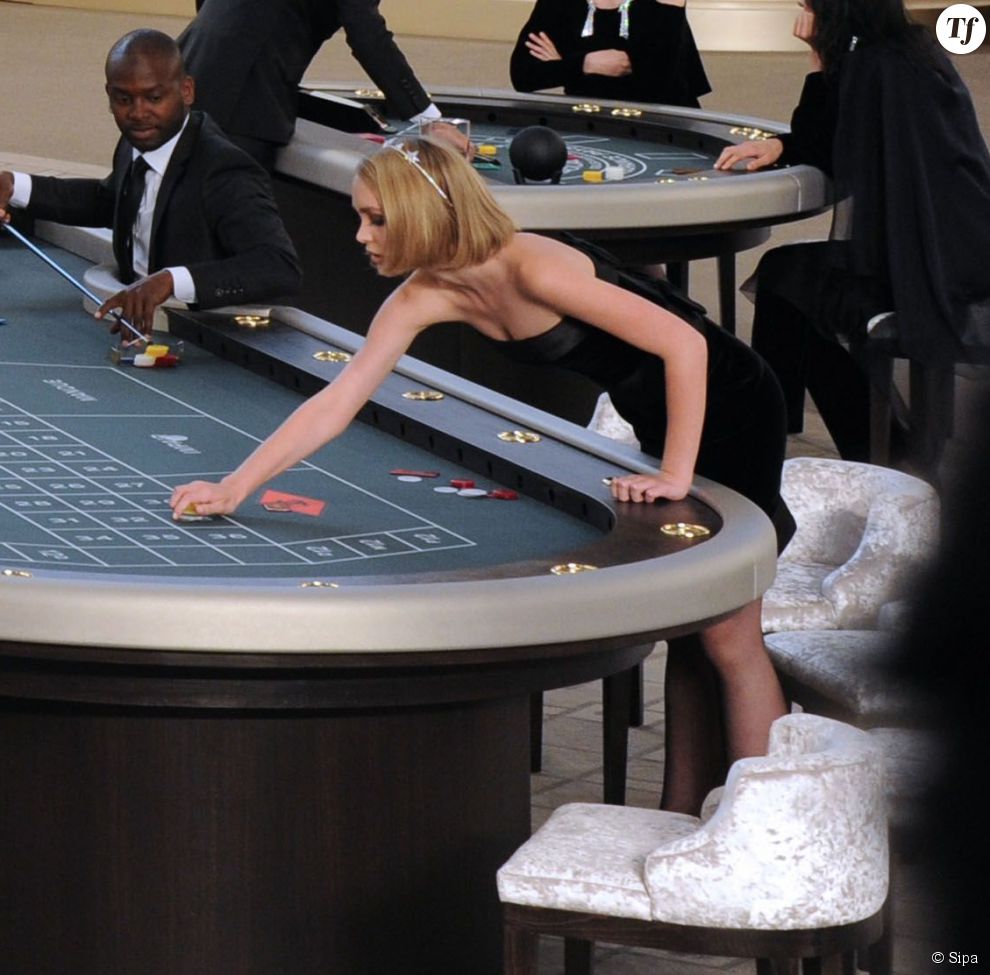 Lily-Rose Depp à la table de jeu du défilé haute couture Chanel le 7 juillet 2015
