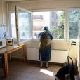  Femme à la fenêtre de la cuisine de son appartement du Centre d'Accueil de Demandeurs d'Asile (CADA) à Villeurbanne (69)/photo d'illustration 