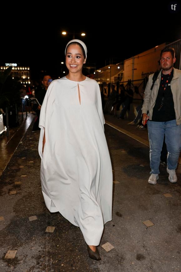 L'influenceuse, dont les deux parents sont Algériens, portait une grande robe large couloir ivoire, assortie à un foulard noué dans ses cheveux lui recouvrant la moitié du crane.